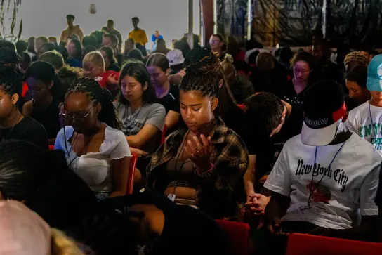 Campers seated and listening during a session